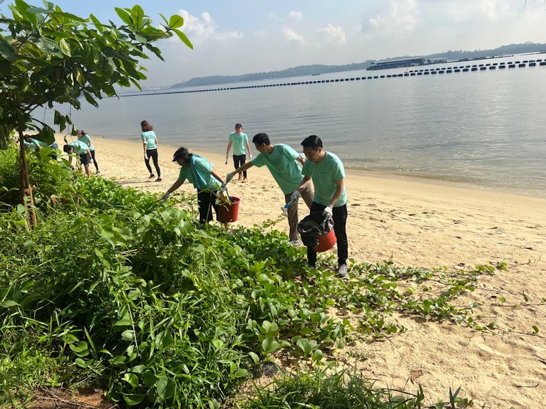 Convergint employees work to clean up a local beach as part of the annual Convergint Social Responsibility Day.