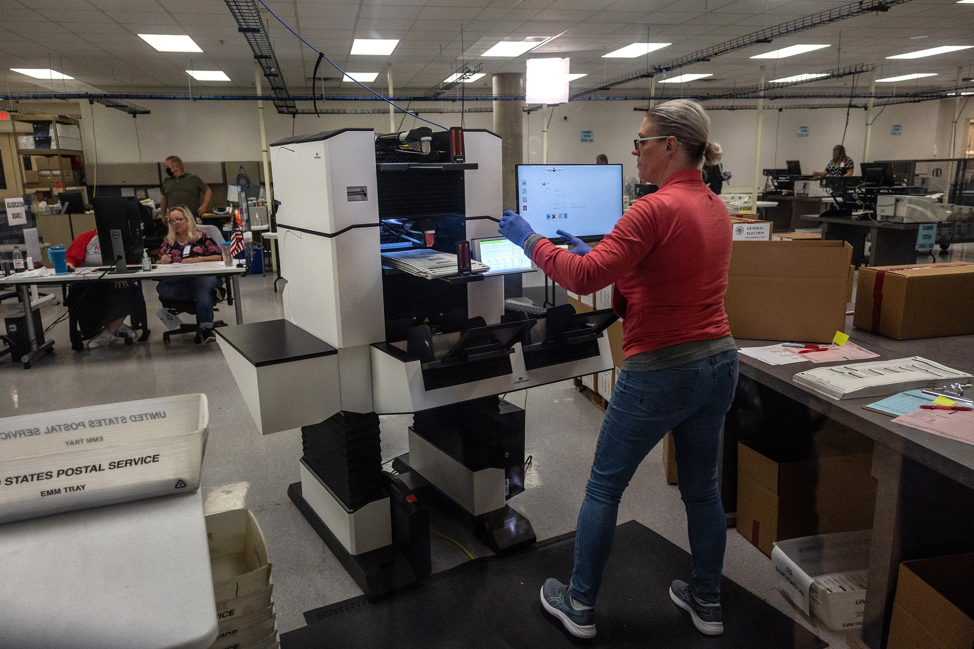 Election workers sort ballots at the Maricopa County Tabulation and Election Center on Nov. 9, 2022 in Phoenix.