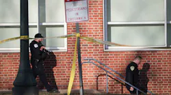 Law enforcement personnel move through the crime scene where three people were killed and two others wounded on the grounds of the University of Virginia on Nov. 14, 2022, in Charlottesville, Va. The suspect is believed to be a student.