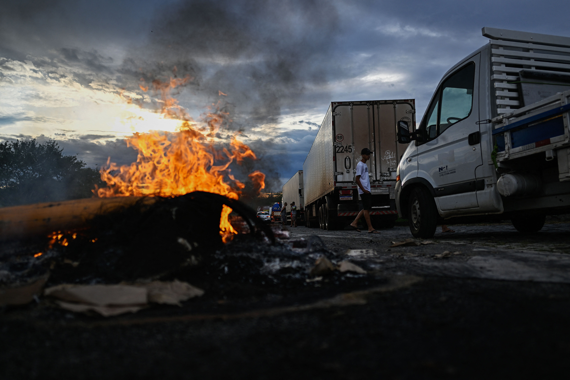 Supporters of President Jair Bolsonaro, mainly truck drivers, set a barrier on fire during a blockade on the Via Dutra BR-116 highway between Rio de Janeiro and Sao Paulo, in Volta Redonda, Rio de Janeiro state, Brazil, on Monday, Oct. 31, 2022, as an apparent protest over Bolsonaro's defeat in the presidential runoff election.