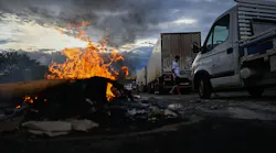 Supporters of President Jair Bolsonaro, mainly truck drivers, set a barrier on fire during a blockade on the Via Dutra BR-116 highway between Rio de Janeiro and Sao Paulo, in Volta Redonda, Rio de Janeiro state, Brazil, on Monday, Oct. 31, 2022, as an apparent protest over Bolsonaro's defeat in the presidential runoff election.