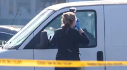 Bullet holes are visible as a coroner's official takes photos on Sunday, Jan. 22, 2023, in Torrance, California. Police say a man in a white van is connected to Saturday night's Lunar New Year mass shooting in Monterey Park. Torrance SWAT officers surrounded the van as the driver appeared slumped over the wheel.