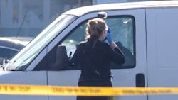 Bullet holes are visible as a coroner&apos;s official takes photos on Sunday, Jan. 22, 2023, in Torrance, California. Police say a man in a white van is connected to Saturday night&apos;s Lunar New Year mass shooting in Monterey Park. Torrance SWAT officers surrounded the van as the driver appeared slumped over the wheel.