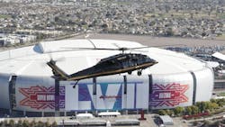 A U.S. Customs and Border Protection Black Hawk helicopter flies above University of Phoenix Stadium, site of the NFL Super Bowl XLIX football game