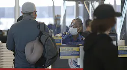 A Transportation Security Administration agent works at the security check area inside Terminal 3 at O'Hare International Airport on Nov. 12, 2020, in Chicago.