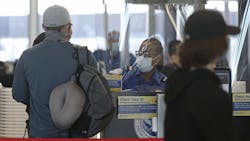 A Transportation Security Administration agent works at the security check area inside Terminal 3 at O'Hare International Airport on Nov. 12, 2020, in Chicago. A Transportation Security Administration agent works at the security check area inside Terminal 3 at O'Hare International Airport on Nov. 12, 2020, in Chicago.