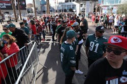 Fans wait in line for the Super Bowl LVII opening night event at the Footprint Center on Monday in Phoenix, Ariz. Fans wait in line for the Super Bowl LVII opening night event at the Footprint Center on Monday in Phoenix, Ariz.