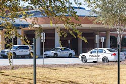 Views of multiple police cars parked at Norcross High School on Thursday, October 27, 2022. The school has increased police presence after a student was fatally shot near the campus.