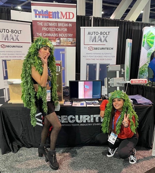 Costumed cannabis enthusiasts stop by the Securitech booth.
