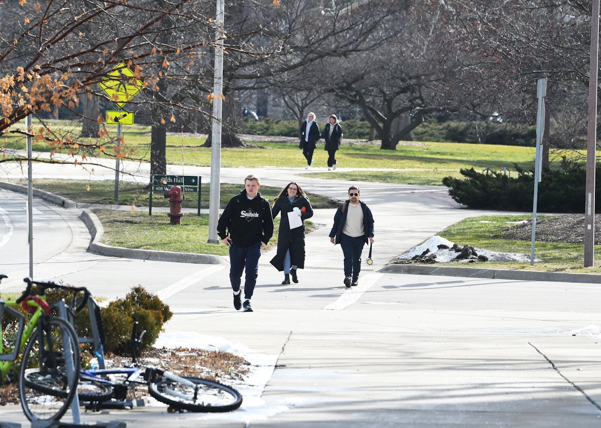 A group of students walking on the Michigan State University campus near the library on the first day of classes since the shooting on Feb. 20, 2023, in East Lansing, Michigan.