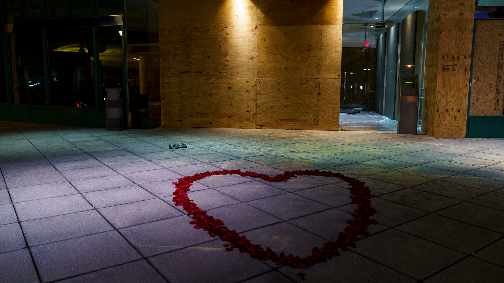 Rose petals lay at the entrance of the Old National Bank on Tuesday, April 11, 2023, in Louisville, Ky. On the morning of April 10, a gunman opened fire inside the bank, killing five people and wounding eight.