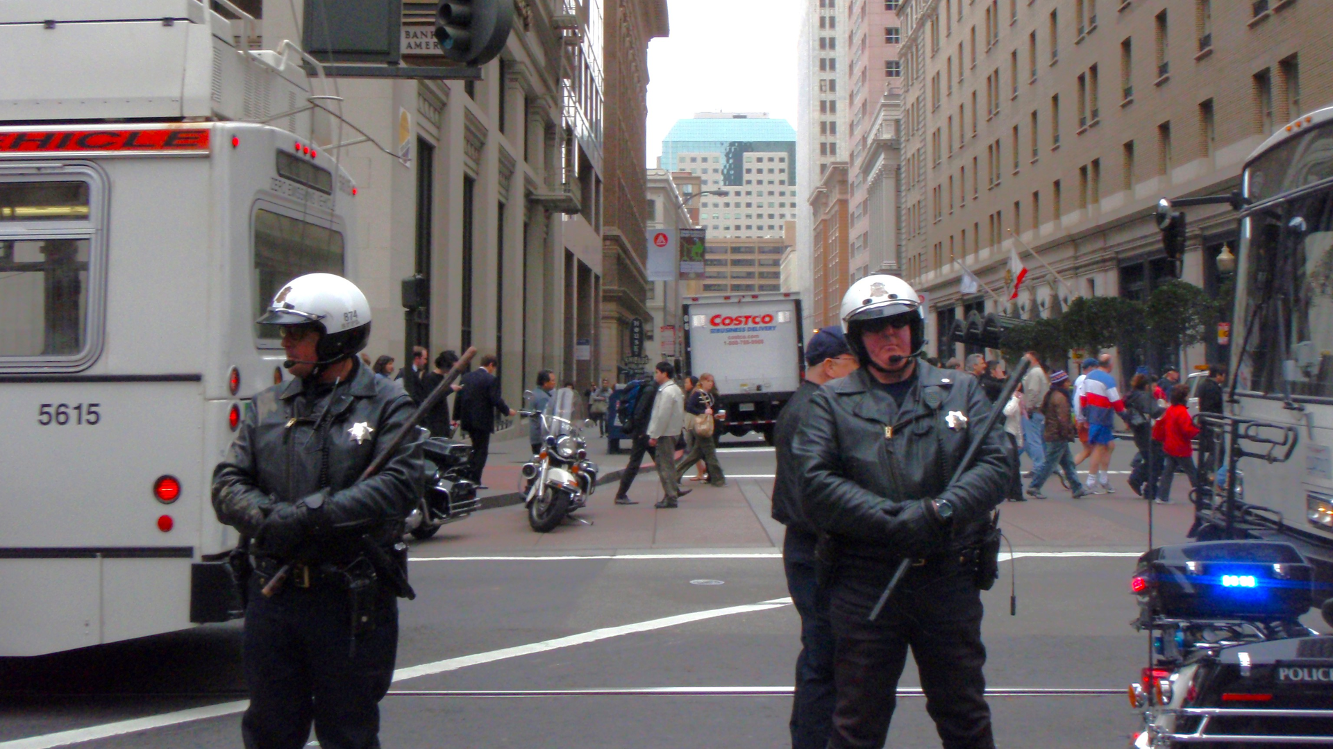 San Francisco police officers hold batons as they block street from protesters during anti war protest. The police were trying to prevent the protesters from continuing their protest by blocking their access to the street.