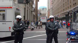 San Francisco police officers hold batons as they block street from protesters during anti war protest. The police were trying to prevent the protesters from continuing their protest by blocking their access to the street.