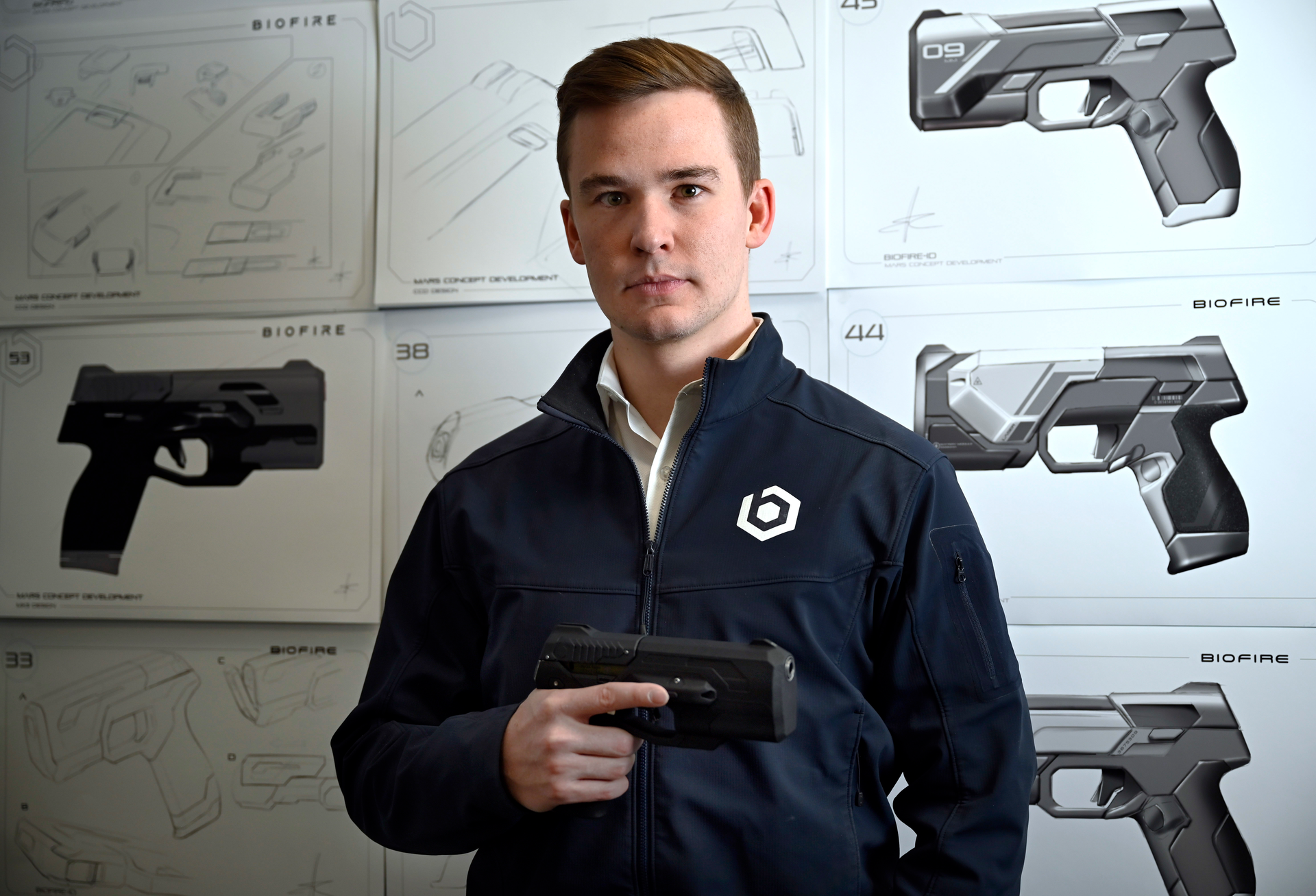 Kai Kloepfer, the founder and CEO of 'smart gun' manufacturer Biofire Technologies, stands for a portrait in the model room against product drawings at the company's corporate headquarters in Broomfield on Friday, April 14, 2023.