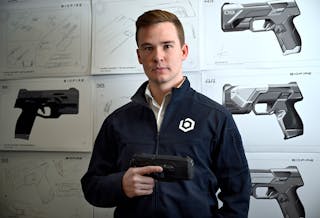 Kai Kloepfer, the founder and CEO of &apos;smart gun&apos; manufacturer Biofire Technologies, stands for a portrait in the model room against product drawings at the company&apos;s corporate headquarters in Broomfield on Friday, April 14, 2023.