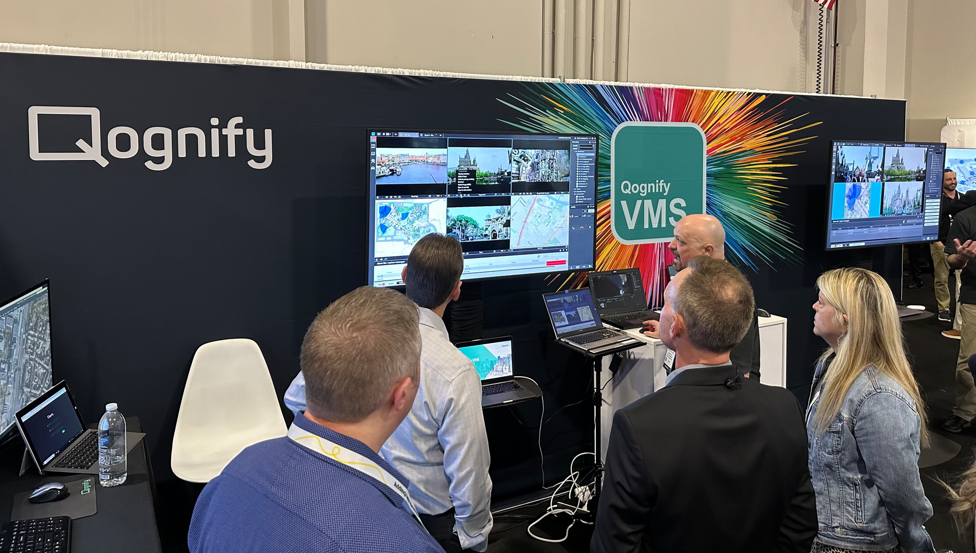 Attendees watch a demonstration of Qognify CMS at Qognify's booth during the ISC West 2023 show in Las Vegas.