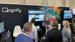 Attendees watch a demonstration of Qognify CMS at Qognify's booth during the ISC West 2023 show in Las Vegas.