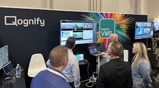 Attendees watch a demonstration of Qognify CMS at Qognify&apos;s booth during the ISC West 2023 show in Las Vegas.