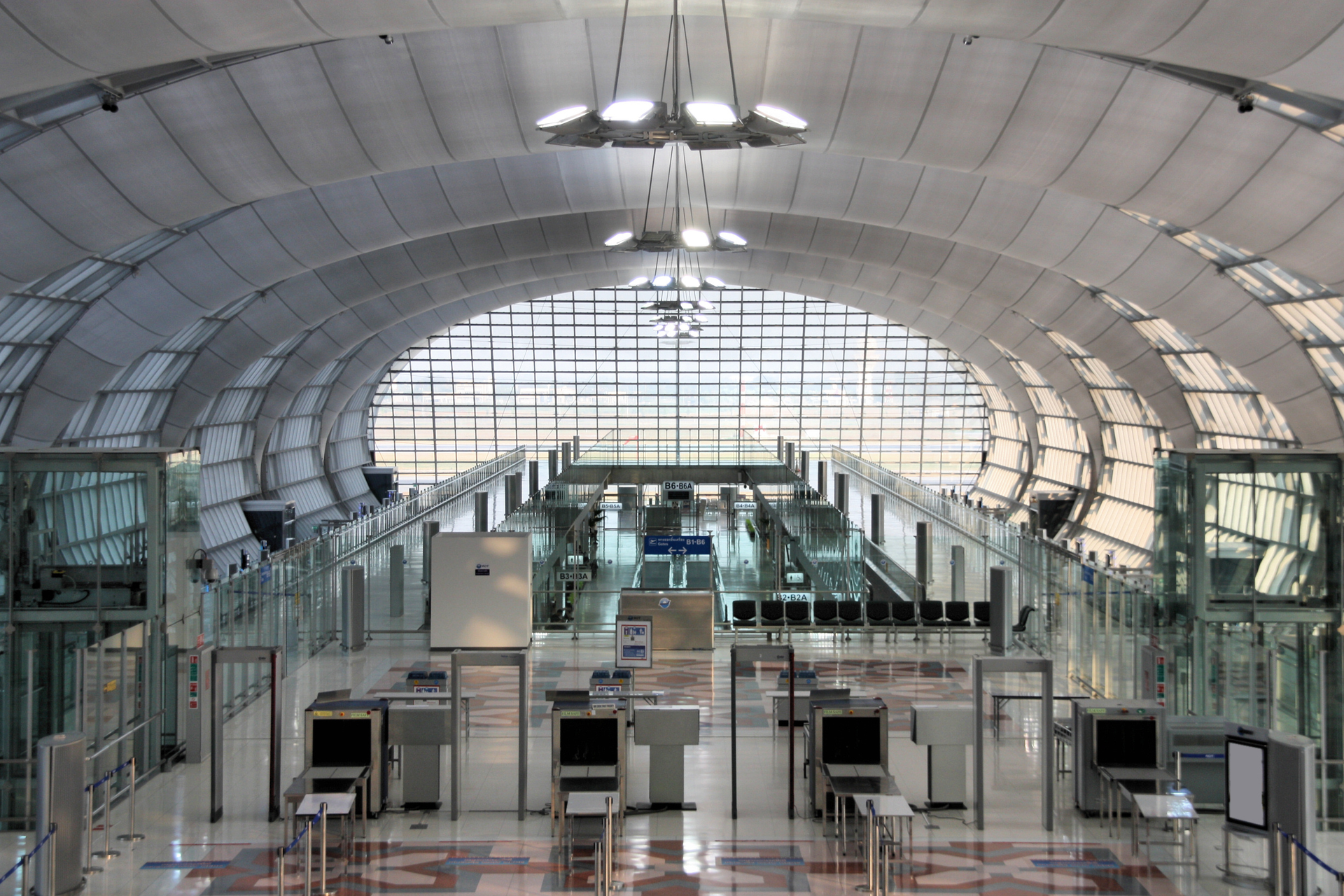 Security control machines and departures area at Bangkok Suvarnabhumi International Airport.