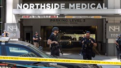 Law enforcement officers are seen on West Peachtree Street in front of Northside Hospital Midtown medical office building, where five people were shot on May 3, 2023.