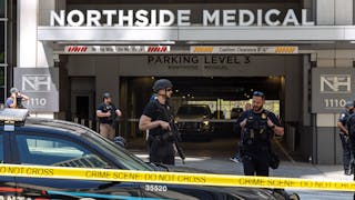 Law enforcement officers are seen on West Peachtree Street in front of Northside Hospital Midtown medical office building, where five people were shot on May 3, 2023.