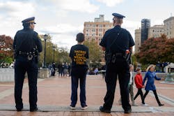 Sam Goldston, 13, stands with 2 Pittsburgh City Police as attendees gather for a public memorial service honoring the lives lost in the attack on the Tree of Life Synagogue on Oct. 27, 2018, at the Soldiers and Sailors Memorial on Oct. 27, 2019 in Pittsburgh, Pennsylvania. One year ago, Robert Bowers killed 11 people and wounded several others during an attack of the Tree of Life synagogue.