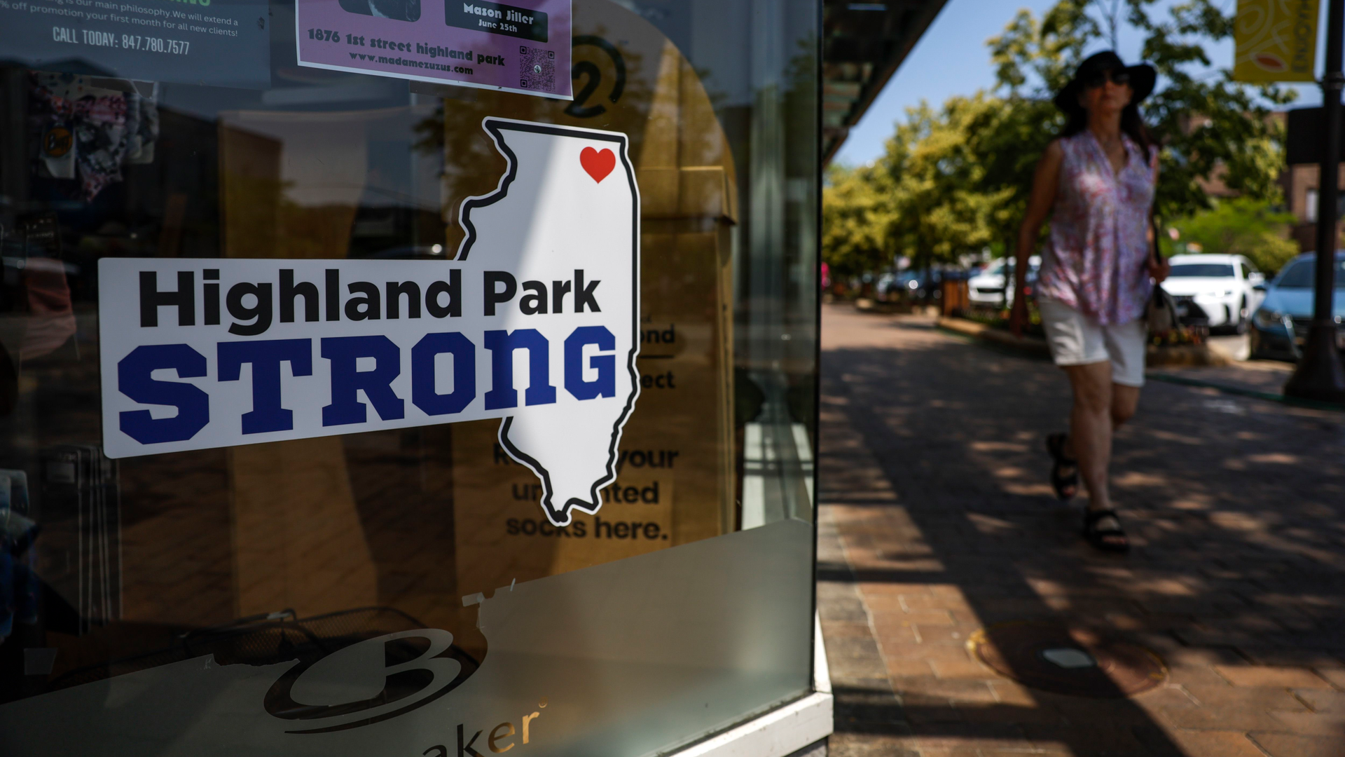 A person walks down Central Avenue on June 24, 2023, in Highland Park, just across from where last year's Fourth of July parade shooting took place.