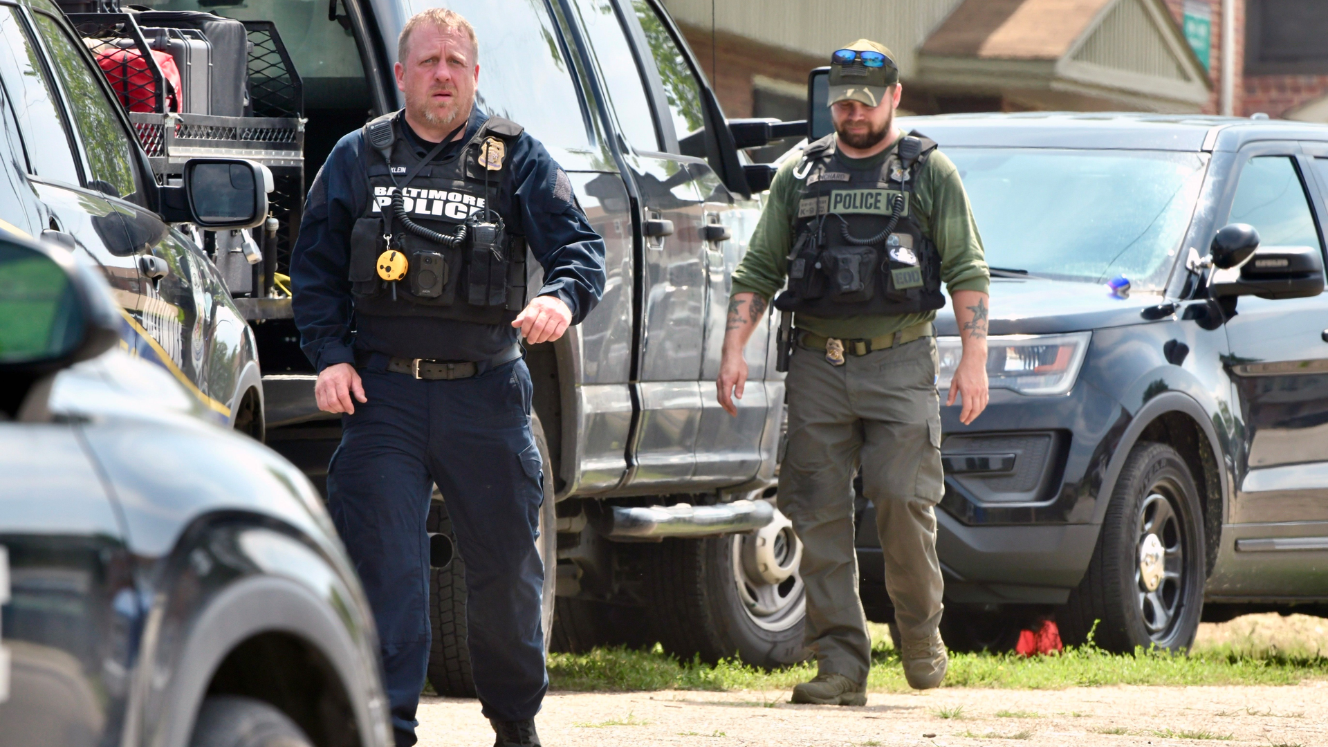 Police officers comb the area near Gretna Court for clues after a block party turned into a shooting scene early Sunday morning. There were 30 shooting victims, including two who died.
