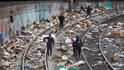 People rummage through stuff stolen from cargo containers littered on Union Pacific train tracks in the vicinity of Mission Boulevard on Saturday, Jan. 15, 2022, in Los Angeles. People rummage through stuff stolen from cargo containers littered on Union Pacific train tracks in the vicinity of Mission Boulevard on Saturday, Jan. 15, 2022, in Los Angeles.