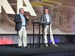 Martin Gren, a co-founder and Deputy Chairman of Axis Communication AB (left), and Fredrick Nilsson, Vice President of the Americas, speak Tuesday at to open the Axis ACCC partner event in Kansas City.
