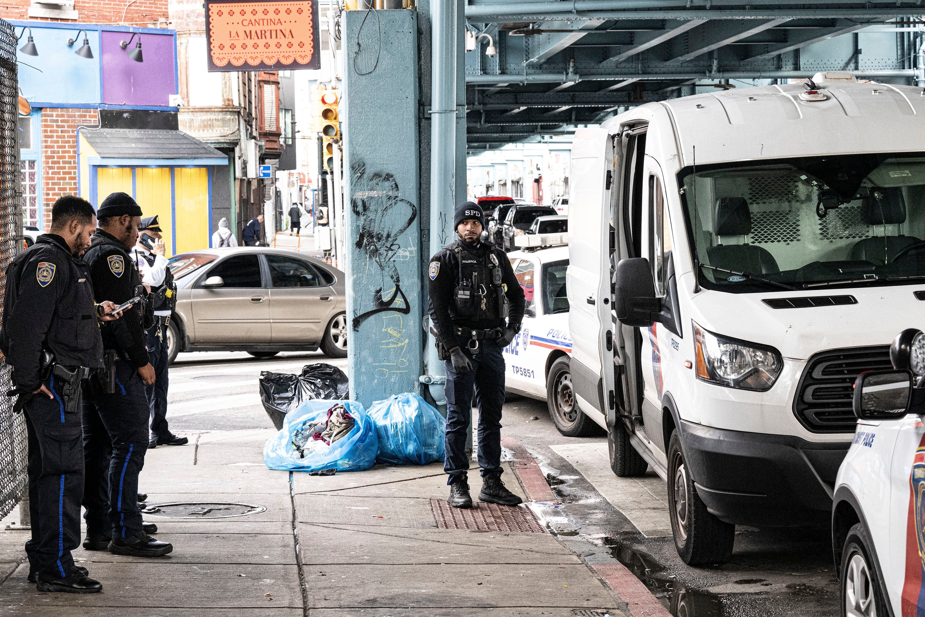 Philadelphia police officers stand near a SEPTA Somerset Station where a suspect was arrested for the stabbing at Macy&rsquo;s on Monday.