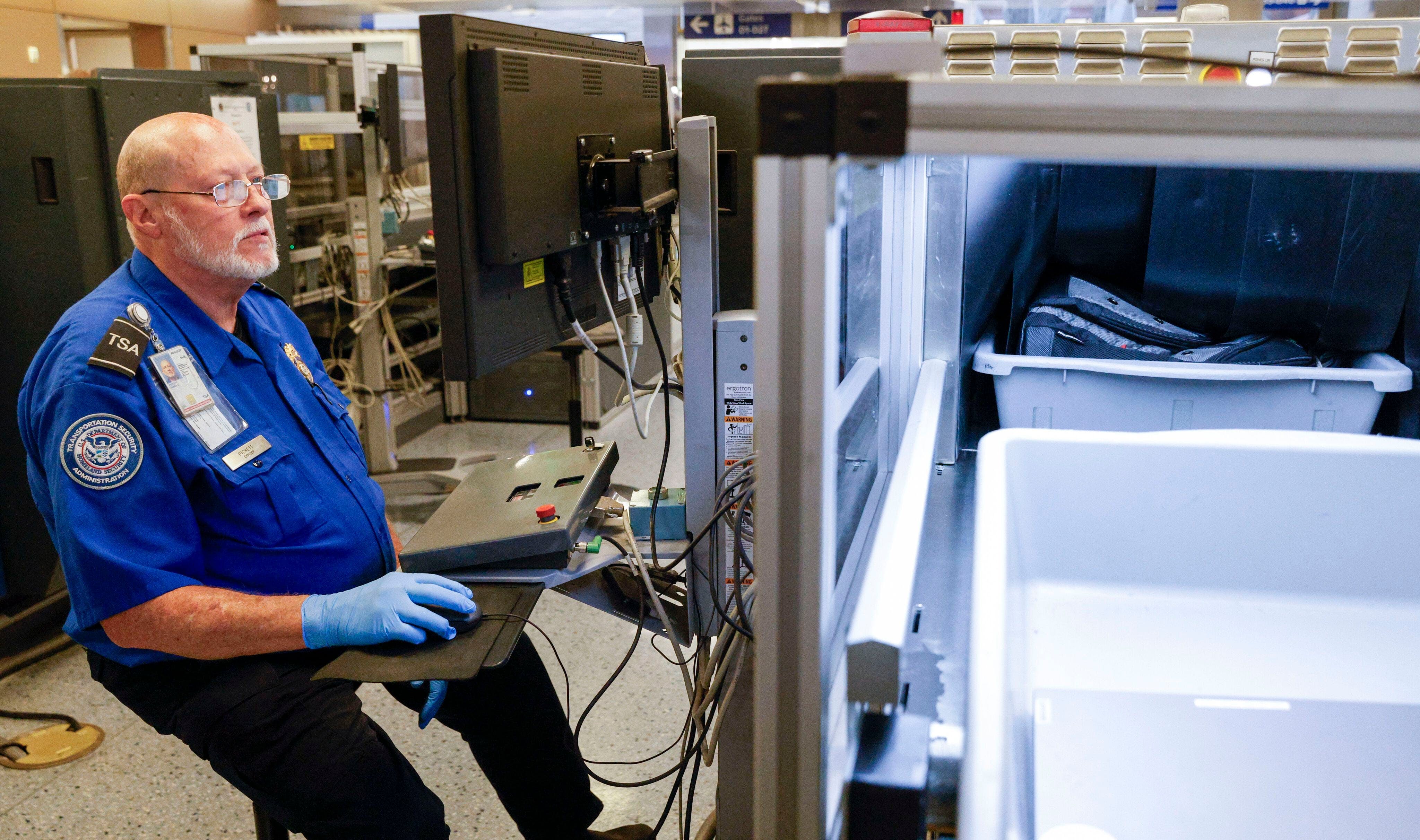 TSA transportation security officer James Pickett checks luggage with an x-ray machine at a security checkpoint inside Terminal D, Tuesday, Aug. 8, 2023 at DFW International Airport.