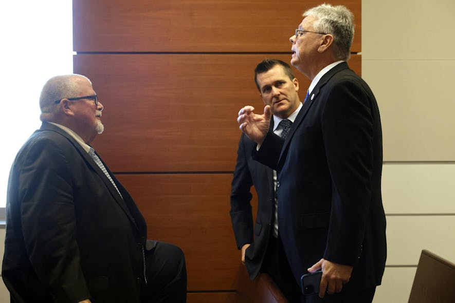 Former Marjory Stoneman Douglas High School School Resource Officer Scot Peterson, right, speaks with his attorney Michael Piper during a break in a hearing regarding the MSD civil cases at the Broward County Courthouse in Fort Lauderdale, Florida, on Monday, Dec. 18, 2023.
