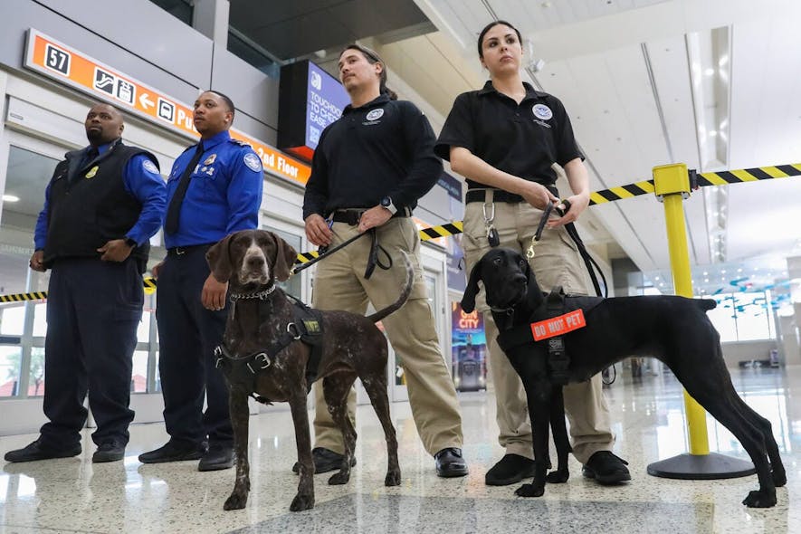 TSA canine handlers Vanessa G., right, with her dog Santi, and George J., alongside his dog Mercy, attend a Super Bowl LVIII safety press conference hosted by the Department of Homeland Security and U.S. Customs and Border Protection held at Harry Reid International Airport on Monday.