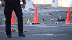 Police officers investigate the scene of a shooting where at least one person was killed and more than 20 others were injured after the Kansas City Chiefs Super Bowl LVIII victory parade Wednesday, Feb. 14, 2024, in Kansas City.