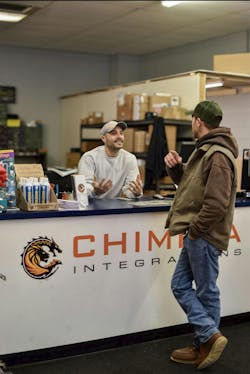 Chimera Integration&apos;s Service Manager, Nick Rock, speaks with a client at their offices.