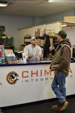 Chimera Integration's Service Manager, Nick Rock, speaks with a client at their offices. Chimera Integration's Service Manager, Nick Rock, speaks with a client at their offices.