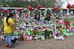 A woman looks down at a memorial for the 19 children and two adults killed on May 24th during a mass shooting at Robb Elementary School on May 30, 2022, in Uvalde, Texas. A woman looks down at a memorial for the 19 children and two adults killed on May 24th during a mass shooting at Robb Elementary School on May 30, 2022, in Uvalde, Texas.