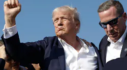 Republican presidential candidate former President Donald Trump pumps his fist as he is rushed offstage by Secret Service agents after being grazed by a bullet during a campaign rally on Saturday in Butler, Pa.
