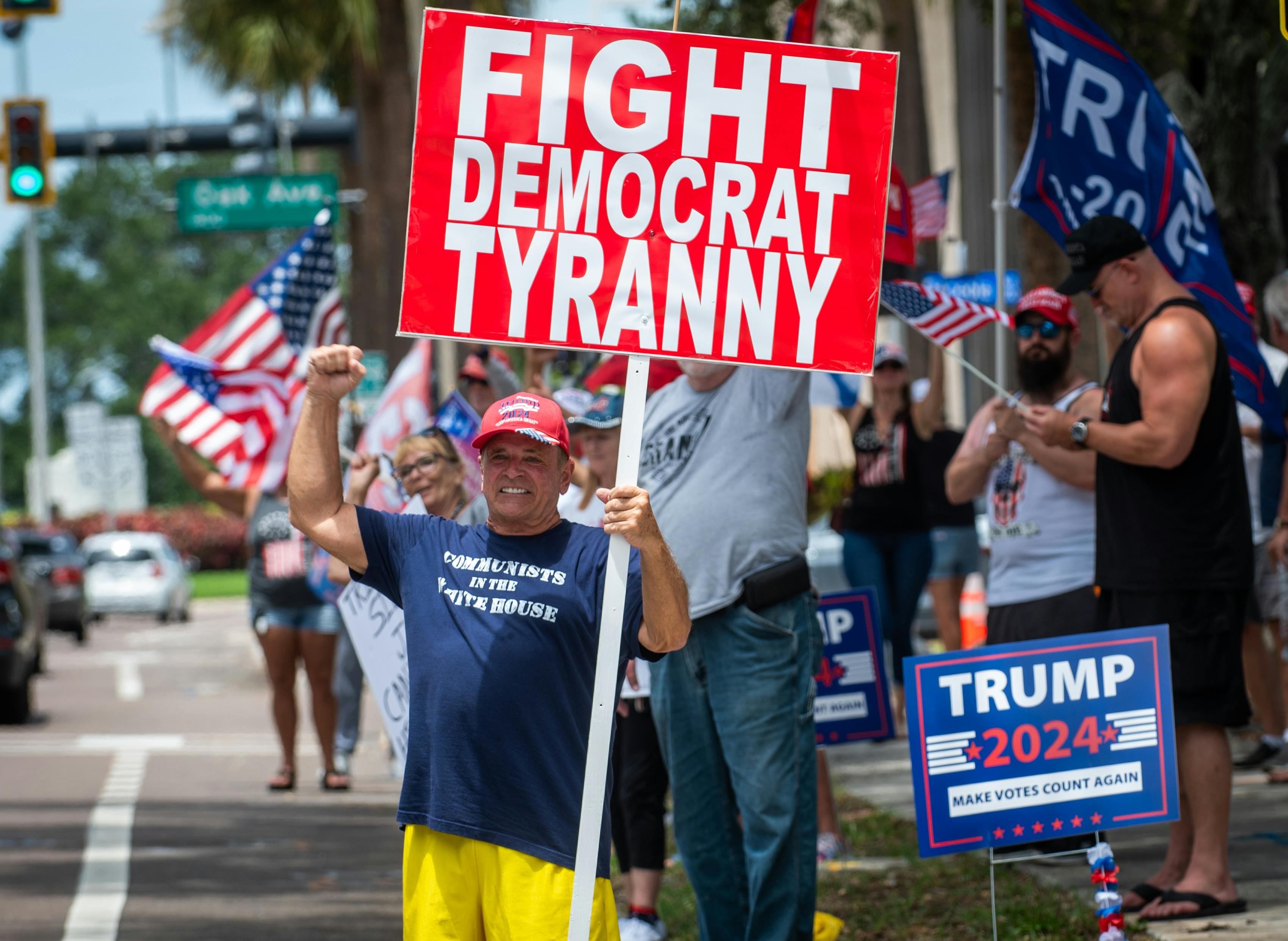 Tom Sartori, 72, of Holiday, holds a sign in support of former President Donald Trump along Court Street in downtown Clearwater on Sunday, a day after the presumptive GOP presidential nominee was injured during an assassination attempt at a rally in Pennsylvania.