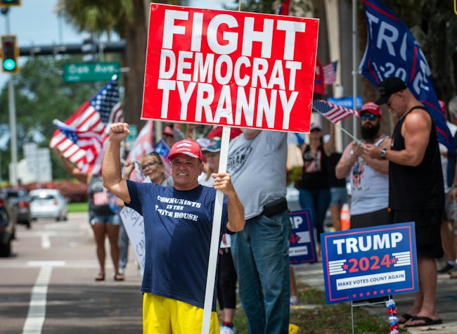 Tom Sartori, 72, of Holiday, holds a sign in support of former President Donald Trump along Court Street in downtown Clearwater on Sunday, a day after the presumptive GOP presidential nominee was injured during an assassination attempt at a rally in Pennsylvania.