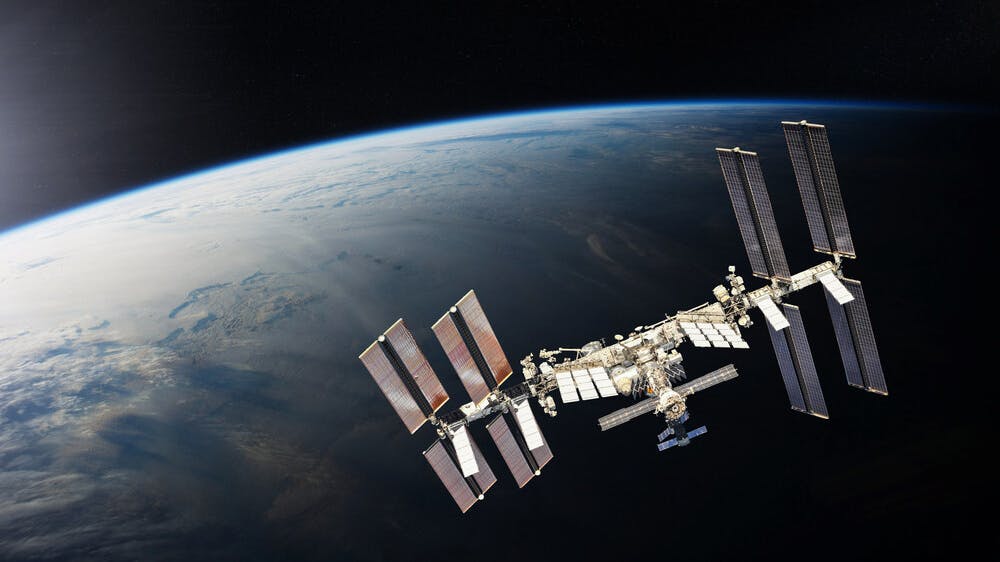 ISS over the planet Earth. Elements of this image furnished by NASA.