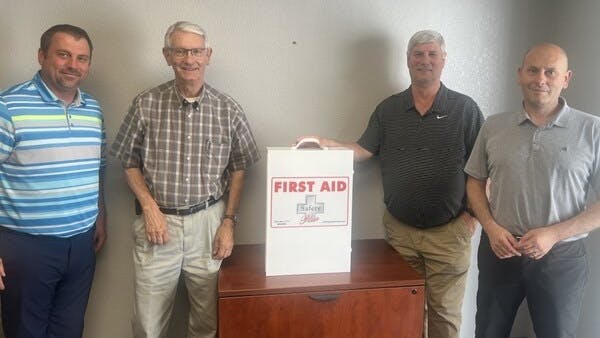 Pye-Barker's Ronnie Unruh, Ron Unruh and Jason Uhrich celebrate the partnership with Max Brown of Safety Plus.