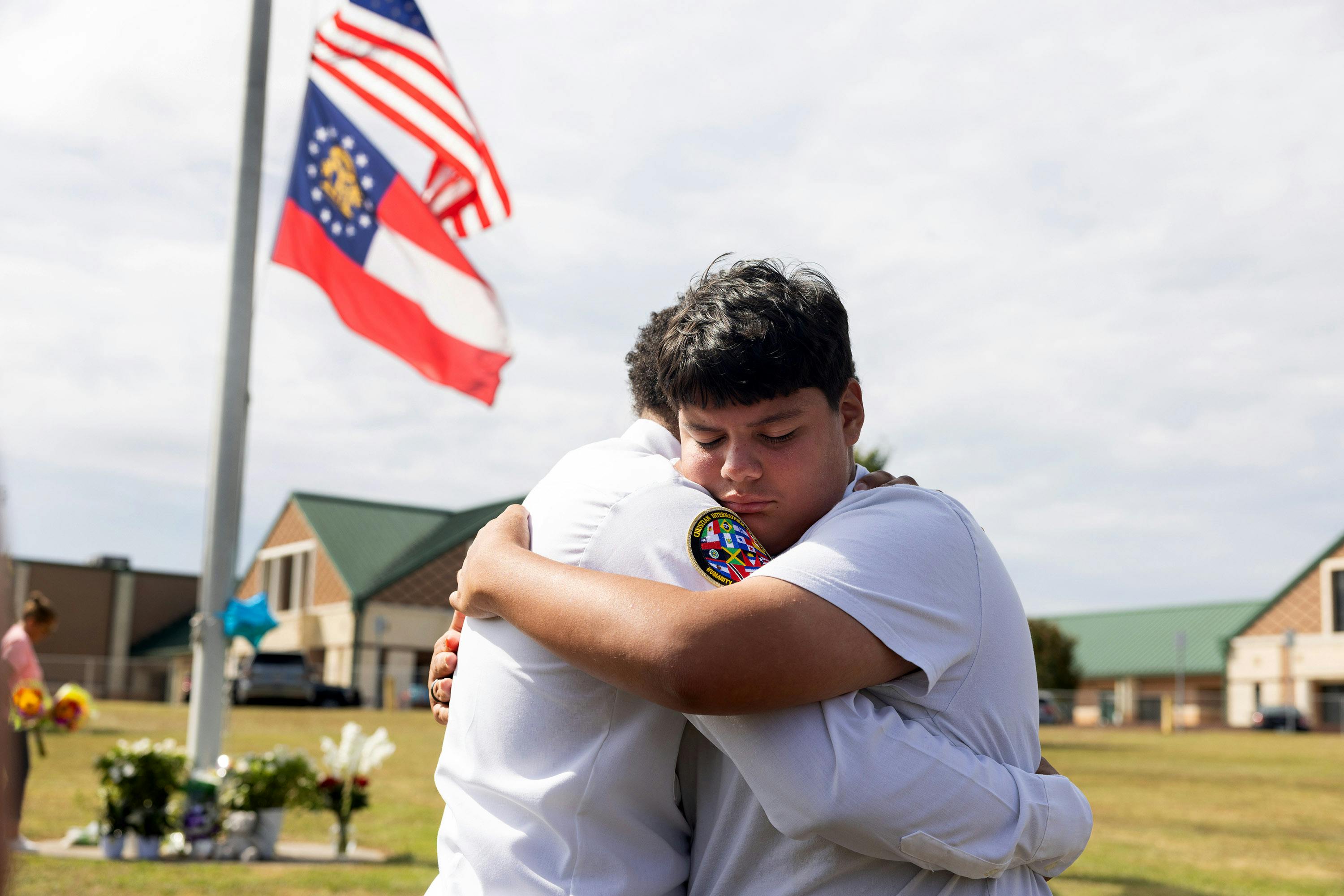 Jose Ortiz, 14 year-old student and friend of one of the victims, is consoled at Apalachee High School on Sept. 5, 2024, in Winder, Georgia. Two students and two teachers were shot and killed at the school on September 4, 2024.