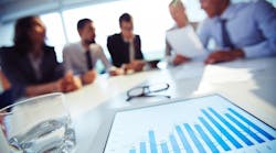 closeupglasswatertabletwithexecutivesbackground_10 closeupglasswatertabletwithexecutivesbackground_10