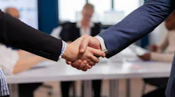 satisfiedbusinessmancompanyemployerwearingsuithand