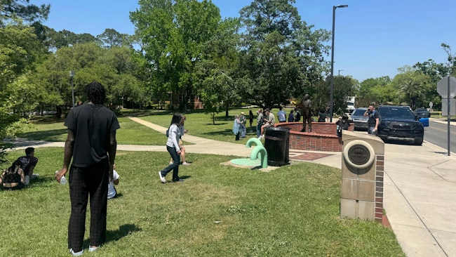 Florida State University students and faculty members wait in a grassy area near the student union where the active shooting was reported. (Ana Ceballos/Miami Herald/TNS)