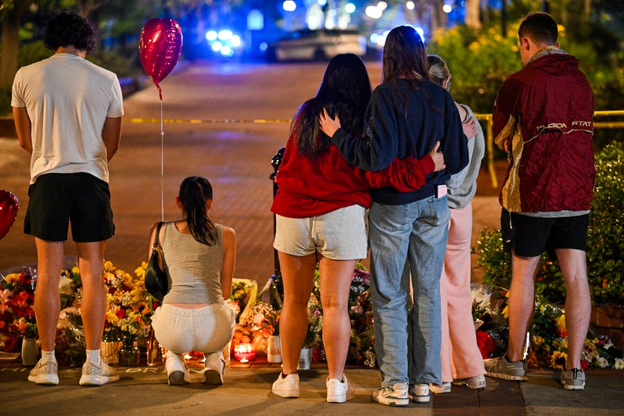 Students hold a vigil near the scene of a shooting near the Florida State University student center on April 17, 2025, in Tallahassee, Florida. Two people were killed and several others injured when the alleged shooter, a current student and the son of a Leon County Sheriff's deputy, opened fire on the university main campus.
