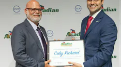 Acadian Companies Vice President Brandon Niles (R) presents Coby Richard (L) with the Acadian Total Security’s 2025 Employee of the Year Award