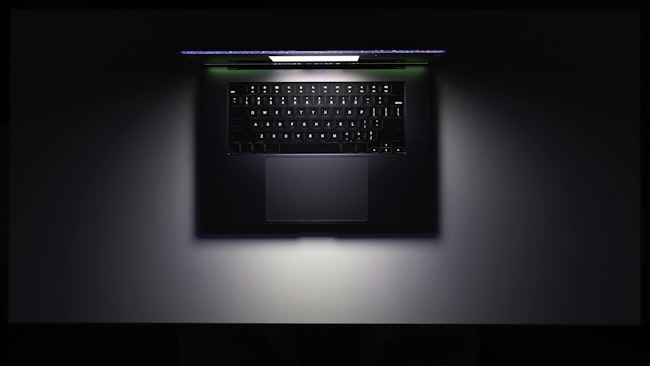 688d01a832030a78312be721 Topviewlaptoptableglowingscreendark